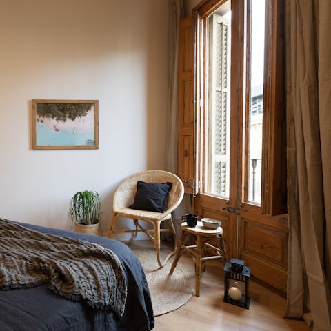 Curl up on the third bedroom's window-side chair while enjoying Eixample views from the Juliet balcony