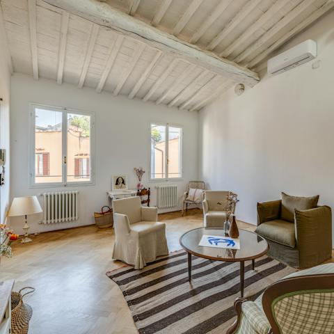 Find time to mingle in the living room, under its characterful wooden ceiling