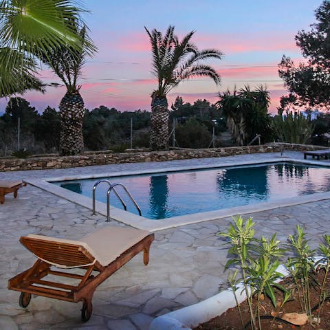 Enjoy an evening dip in the private pool underneath the pink sky