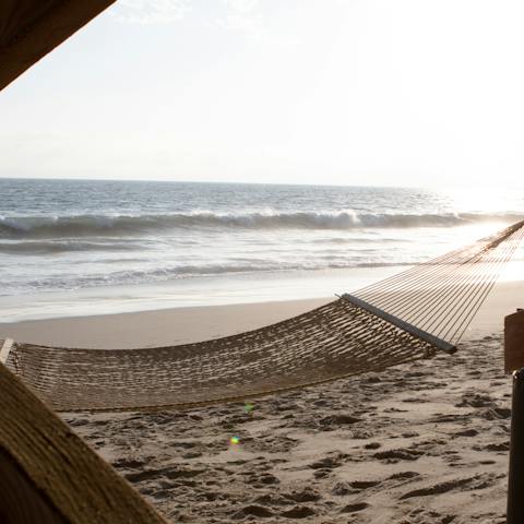 Listen to waves lapping on the shore as you recline in the hammock