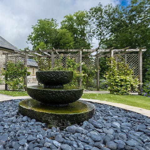 Listen to the soothing sounds of the garden water feature 