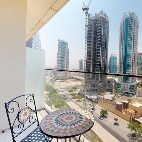 Enjoy the cityscape from the private balcony