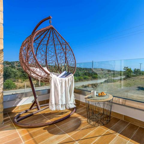 Take in the views or read a book in the swinging chair on the balcony 