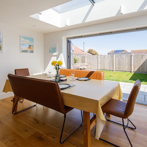 Open the folding doors to let in the sea air and gather around the dining table for a hearty dinner