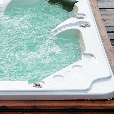 Relax in a hot tub, with a cold drink in hand and instantly calming vistas before you