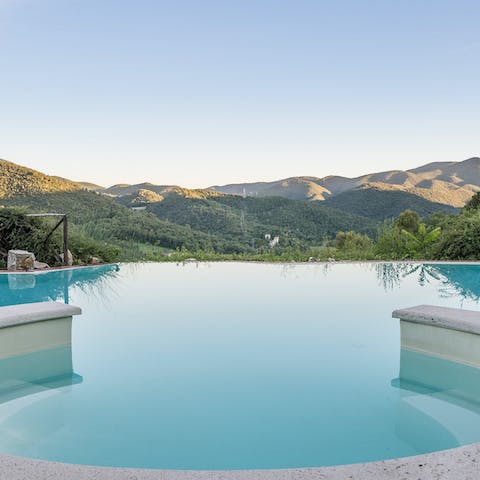 Watch the sun go down from the curved jacuzzi in the infinity pool