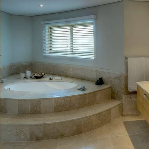 Treat yourself to a relaxing soak in the sunken bathtub