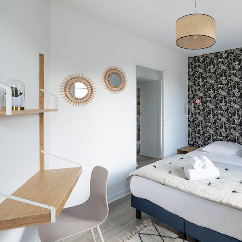 Catch up on emails from the sleek bedroom workspace 