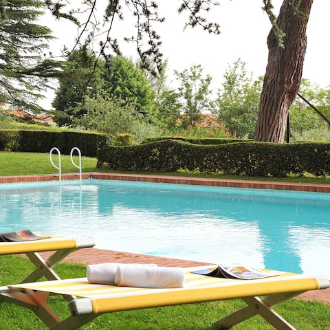 Swim laps in the pool to cool off from the Tuscan sun