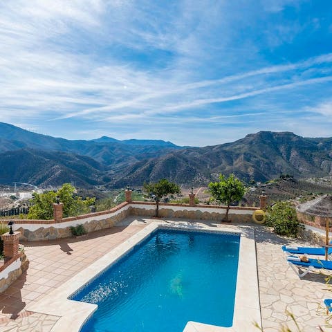 Splash around in the pool while feeling in awe of the scenery around you