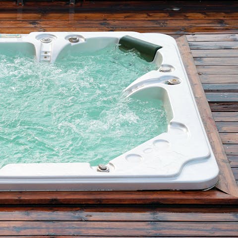 Treat yourself to a long soak in the hot tub, glass of Champagne in hand