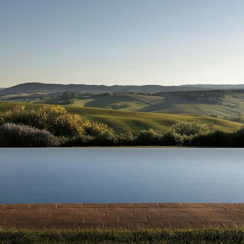 Float in the infinity pool and take in the view of the Tuscan hills