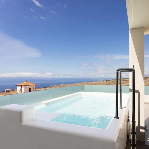 Admire far-reaching ocean views while relaxing in the private hot tub