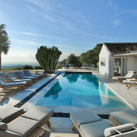 Relax by the glistening pool with stunning vistas all around you