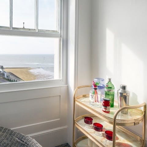 Shake up a cocktail using the bar cart accoutrements and watch the tide draw in