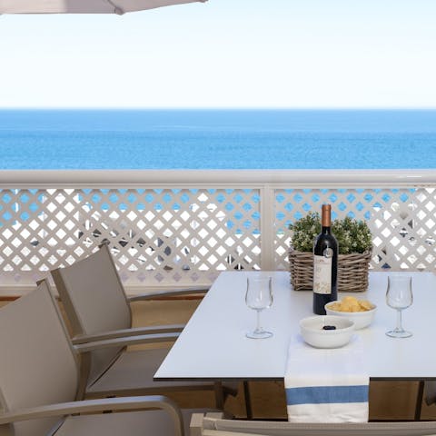Drink in the sea views over an alfresco meal on the private balcony