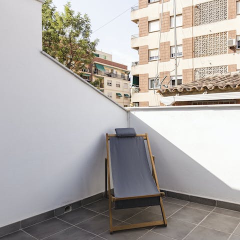 Read in the sun from this lounge chair on the balcony