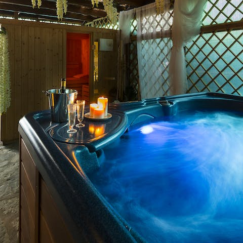 Pop open a bottle of fizz and relax in the private hot tub 