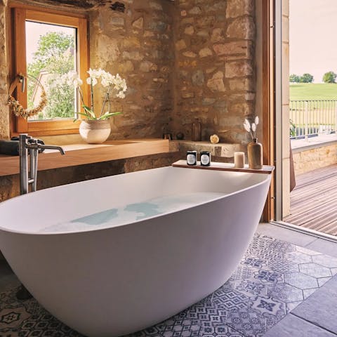 Greet the outdoors in the serene bathtub overlooking the garden
