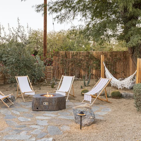 Toast marshmallows over the fire pit after dozing in the hammock