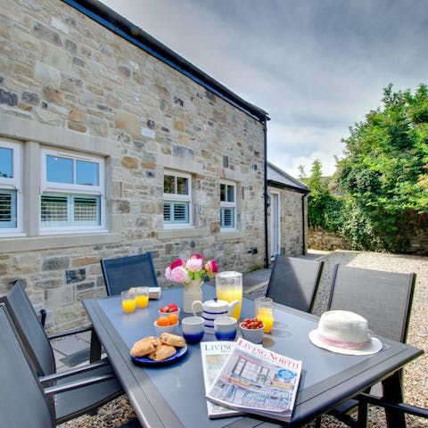 Embrace lazy mornings sipping coffee and tucking into breakfast in the bright garden