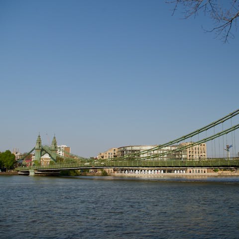 Stroll along the Thames towards Hammersmith Bridge, a thirteen-minute walk away