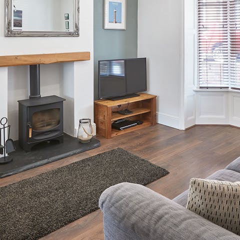 Get cosy on the sofa in the comfortable living room with a nice glass of wine and the fire crackling on