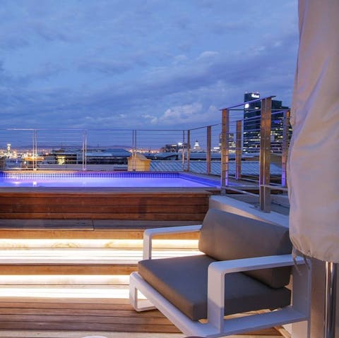 Enjoy an evening dip in the rooftop pool with incredible views over the city