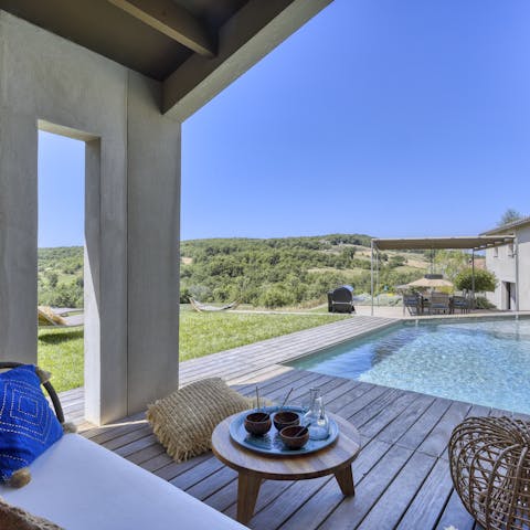 Unwind in the shade on the private pool deck, overlooking hilly hiking trails