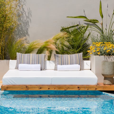 Stretch out on the daybed and dip your toes into the cooling waters of your pool