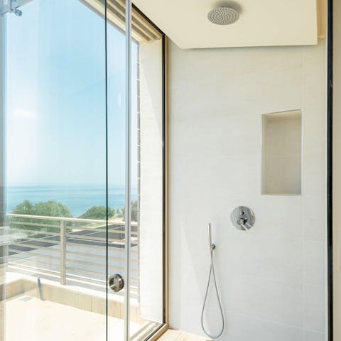 Look out to sublime views of the Aegean Sea from the glass-walled shower