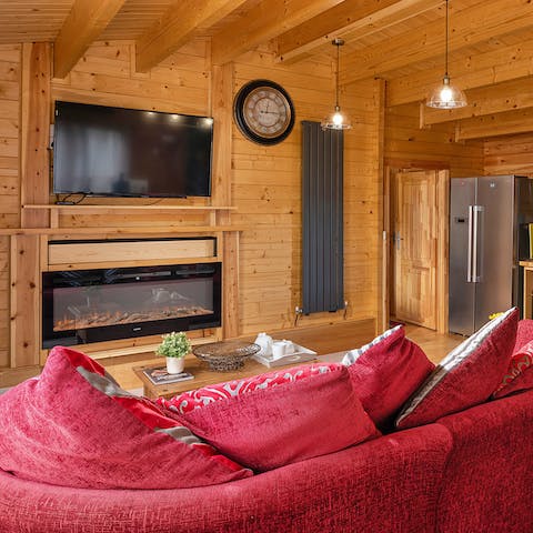 Turn on the fireplace during the cooler months and snuggle on the sofa