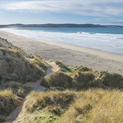 Wander down the sandy path towards Gwithian Beach, ideal for sunbathing, surfing and swimming in the sea