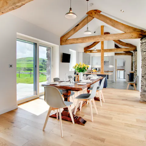 Gather around the dining table beneath the wood-beamed ceiling for relaxed dinners at home