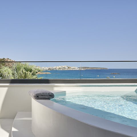 Relax in the Jacuzzi while taking in stunning sea views