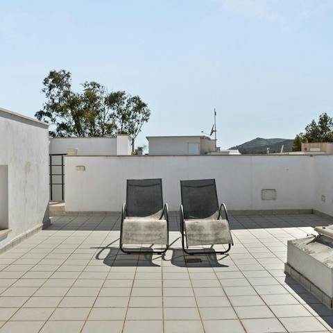 Soak up the sunshine on one of the rooftop loungers