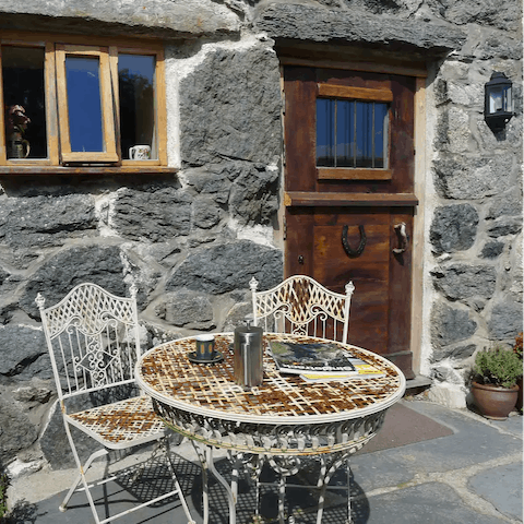 Sip your morning coffee on the quaint outdoor table 