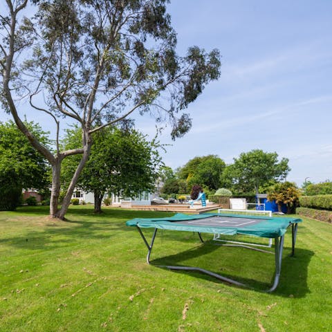 Let the kids have fun bouncing on the trampoline and playing in the garden