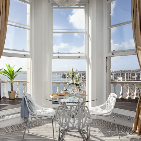 Admire stunning sea views through the triple sash windows in the light-filled living room