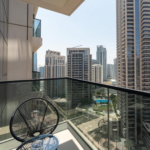 Take in the iconic view of skyscrapers from the private balcony