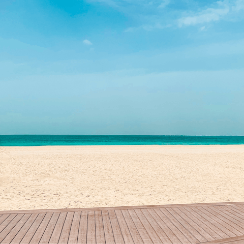 Relax on Jumeirah Beach, a fifteen-minute drive away
