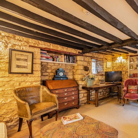 Admire rustic features like the wooden beams, exposed brickwork, and antique furniture