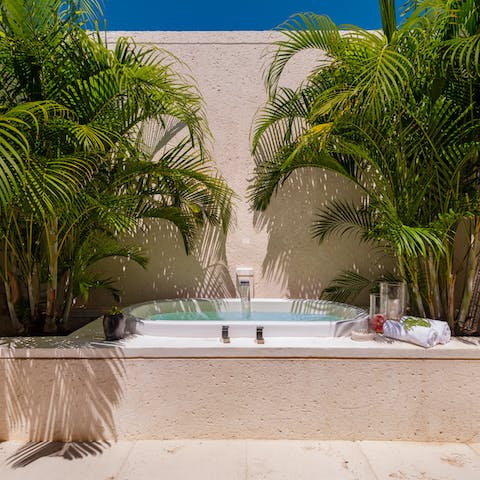 Bathe beneath the blue sky in the main bedroom's indoor-outdoor bathroom