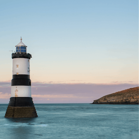 Gaze out at Puffin Island from the tranquil pebble beach at Penmon Point, 19 miles away