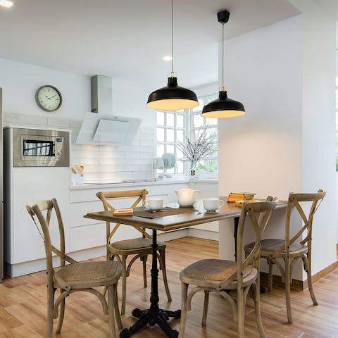 Gather around the dining table for relaxed dinners at home, with the low-hanging light fixture setting the mood