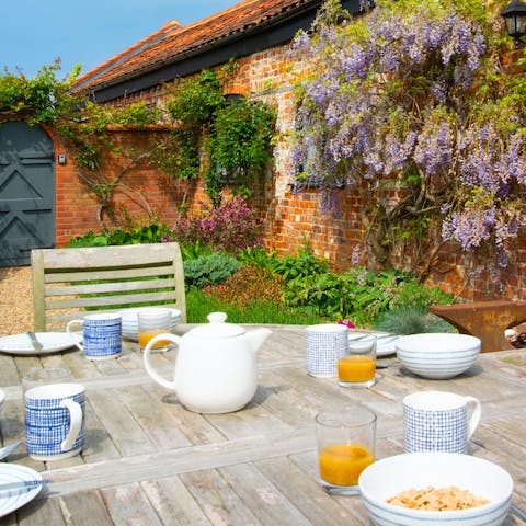 Sit down to an alfresco breakfast in the garden next to the fragrant wisteria 
