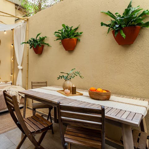 Enjoy some Catalan delicacies from the patio's dining area 