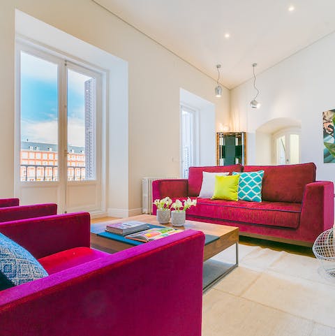Kick back and relax in the bright living room with its privileged views of the plaza