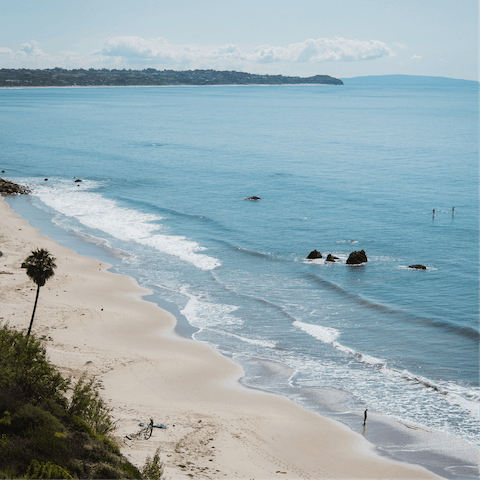 Enjoy a sunrise surf down at Malibu Beach, a fifteen-minute drive away