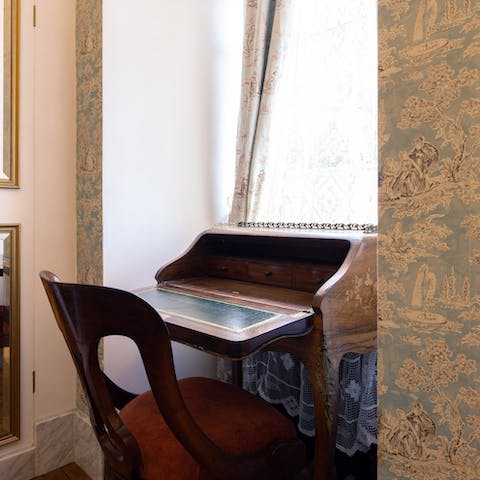 Catch up on work at the bedroom's antique bureau 